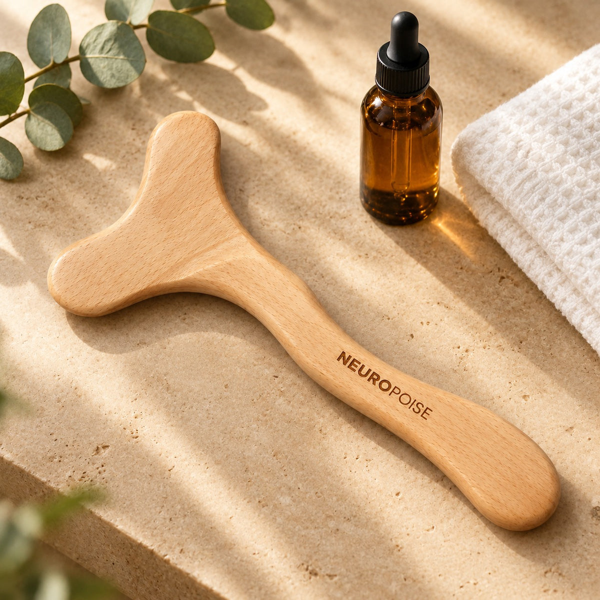 Wood Therapy Body Massager on a stone vanity with body oil
