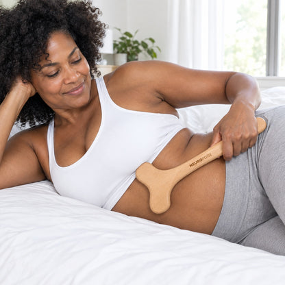 Woman gliding the Wood Therapy Body Massager along her waist