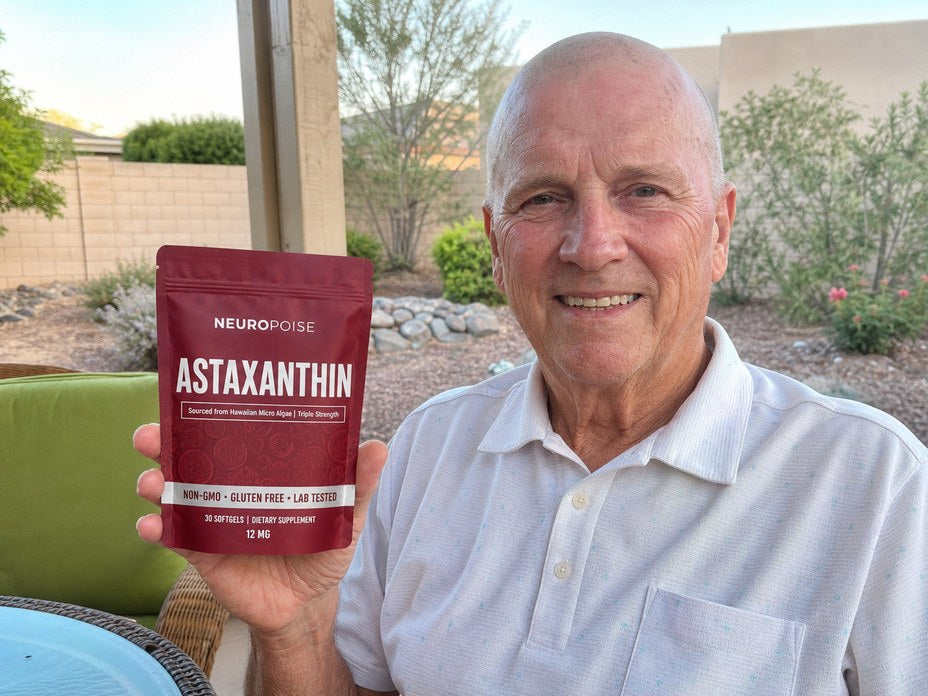A man holds a deep red pouch of Neuropoise Astaxanthin.